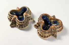 A PAIR OF DOULTON LAMBETH STONEWARE CLOVER SHAPED SALTS by E.S. 1874. 3.5ins.