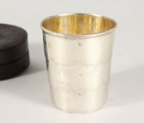 A SILVER TELESCOPIC THREE-SECTION COLLAPSIBLE CUP in a leather case.
