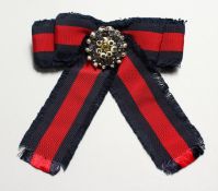 A GUCCI FRAYED RED AND BLUE COTTON-GROSGRAIN AND CRYSTAL BROOCH.