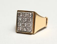 AN 18CT GOLD DIAMOND SET SQUARE RING.
