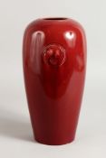A WILLIAM MOORCROFT RED VASE OF CHRISTOPHER DRESSER DESIGN. 12ins high.
