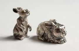 TWO MINIATURE CAST SILVER RABBITS.