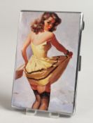 A METAL ENGINE TURNED CIGARETTE CASE, the top with a glamour model, windy day.