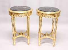 A PAIR OF GILTWOOD CIRCULAR TABLES with marble tops.