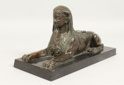 AFTER THE ANTIQUE A BRONZE SPHINX. 10ins long.