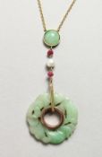 A JADE AND GOLD PENDANT.