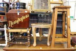 Two stools a table and a magazine rack.