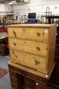 A 19th century pine small three drawer chest.