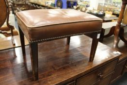 A George III style leather upholstered stool.
