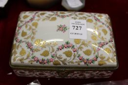 A French Limoges porcelain box and cover with enamel decoration.