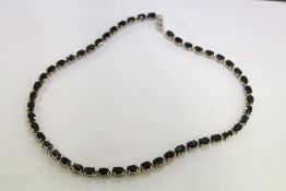 A decorative silver necklace.
