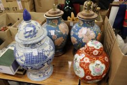 A pair of Chinese lamps, a ginger jar and cover and a blue and white jar and cover.