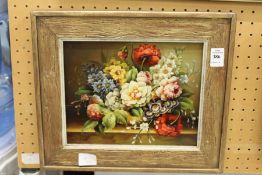 M. Grant, a still life of flowers in a vase on a ledge, oil on board.