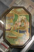 An Indian octagonal shaped lacquer box with pictorial cover.