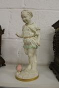 An unusual Worcester part glazed Parian figure of a young girl kicking a ball.