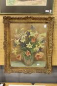 A still life of flowers in a vase. Printed on board, in a decorative frame.