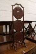 A mahogany three tier folding cake stand.