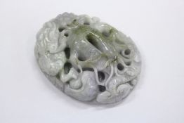 A carved jade amulet.
