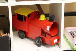 A painted tin plate model of a train.