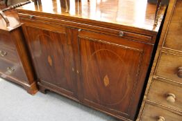A 19th century mahogany two door cupboard with brushing slide.