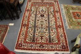A modern Persian rug, beige ground with allover floral decoration.