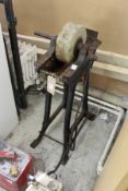 An old wrought iron treadle operated grinding wheel.