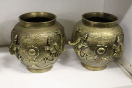 A pair of Chinese bronze vases moulded with dragons.