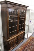 A large oak bookcase with cupboard base.