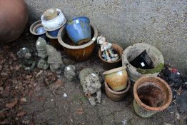 A quantity of pot plants and ornaments.