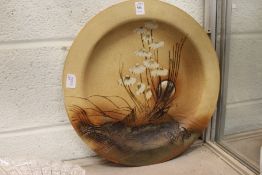 An unusual moulded and decorated pottery charger.