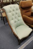 A Victorian walnut framed button upholstered bedroom chair.