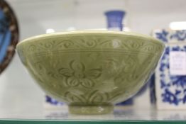 A Chinese celadon bowl with incised decoration.