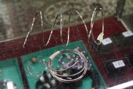 A flexible silver bracelet.