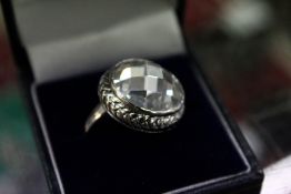 A large silver and zircon ring.