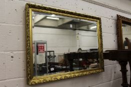 A decorative gilt framed wall mirror.