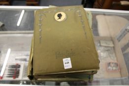 An early 20th century postcard album and contents.