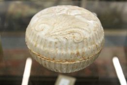 A Chinese white glazed moulded pottery box and cover.