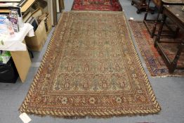 An unusual Persian rug, rust ground with large stylized boteh decoration.