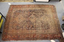 A Persian rug, worn.