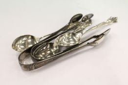 Silver sugar tongs and spoons.