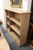 A stained pine shelf unit.