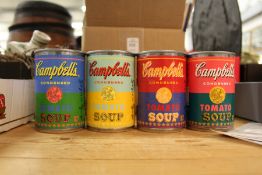 Four Andy Warhol tins of Campbell's condensed tomato soup.