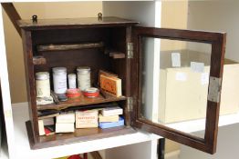 A smoker's cabinet containing snuff and other tobacco related items.