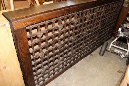 A large lattice work wooden radiator cover.