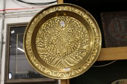 An embossed brass dish.