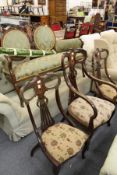 A late Victorian inlaid walnut salon suite comprising a two seater settee, an armchair and a pair of