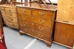 A George III mahogany straight front chest of two short and three graduated long drawers on ogee