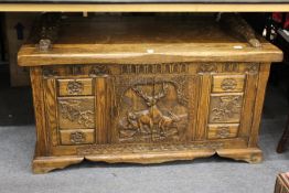 A carved oak reproduction coffer.