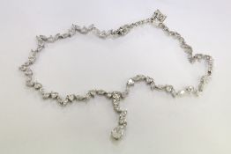 A decorative silver necklace.