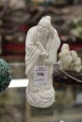 A small Chinese blanc-de-chine figure of a scholar.